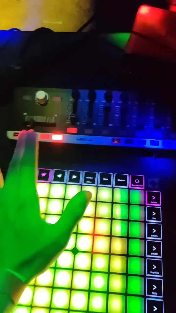 Video of launchpad being used to control strobing colorful lights with people dancing.
